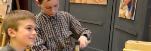 Young children woodworking with traditional hand tools